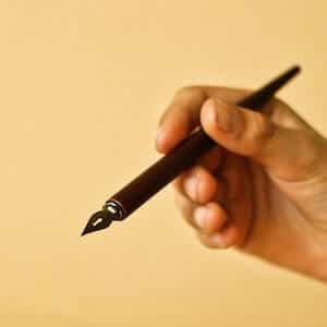 Author's hand holding a pen